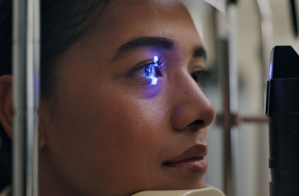 A close-up of a patient's eye illuminated by a slit lamp during a routine exam to check for any irregularities.