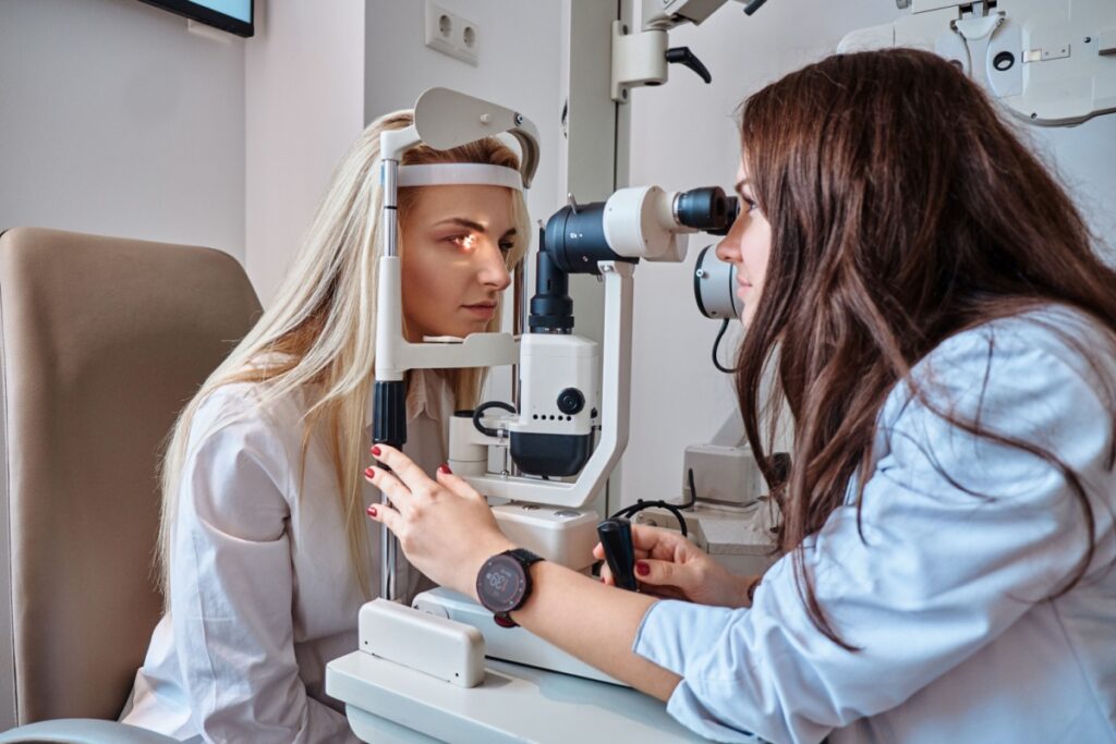 A person having an annual eye exam with their optometrist to monitor for eye conditions.