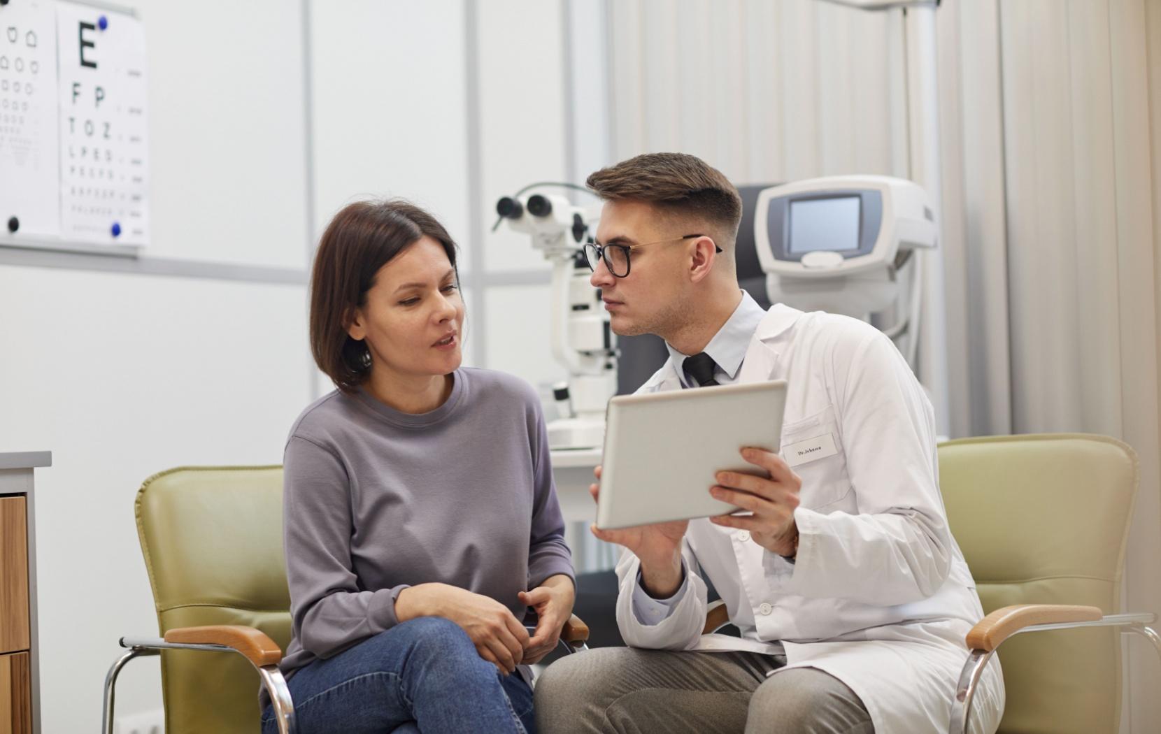 An eye doctor and patient discussing the cause of the patient's excessive watery eyes.